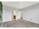 Bright bedroom with gray walls and carpet, featuring doors to the ensuite bathroom and walk-in closet at 8570 Hudson Way, Brownsburg, IN 46112