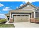 Spacious two-car garage with carriage-style doors and brick accents complementing the home's facade at 8570 Hudson Way, Brownsburg, IN 46112