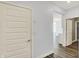 Bright hallway with wood floors and white doors, offering a glimpse into the home's open layout at 8570 Hudson Way, Brownsburg, IN 46112
