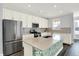 Spacious kitchen with white cabinetry, stainless steel appliances, and an island with a unique design at 8570 Hudson Way, Brownsburg, IN 46112
