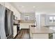 Well-lit kitchen featuring a center island, stainless steel appliances, and modern finishes at 8570 Hudson Way, Brownsburg, IN 46112