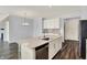 Bright and airy kitchen showcasing an island with sink, quartz countertops, and stainless appliances at 8570 Hudson Way, Brownsburg, IN 46112
