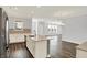 Open concept kitchen with a large island, stainless steel appliances, and hardwood floors at 8570 Hudson Way, Brownsburg, IN 46112
