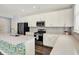Modern kitchen with white cabinets, stainless steel appliances, and a central island with a sink at 8570 Hudson Way, Brownsburg, IN 46112