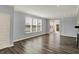 Spacious living room with abundant natural light through large windows and wood flooring at 8570 Hudson Way, Brownsburg, IN 46112