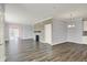 Open-concept living room featuring wood floors, a fireplace, and modern lighting fixture at 8570 Hudson Way, Brownsburg, IN 46112