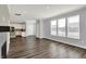 Bright living room with wood floors, large windows, seamlessly connecting to the kitchen at 8570 Hudson Way, Brownsburg, IN 46112