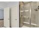 Modern bathroom featuring a glass shower enclosure with tiled walls and a built-in bench at 8570 Hudson Way, Brownsburg, IN 46112