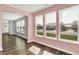 Bright sunroom with wood floors and large windows offering natural light and neighborhood views at 8570 Hudson Way, Brownsburg, IN 46112