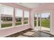 Sunroom with wood floors, neutral walls, and windows offering natural light and backyard views at 8570 Hudson Way, Brownsburg, IN 46112