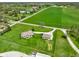 An aerial view shows a house with expansive green pastures and lush trees in the neighborhood at 8890 N Pennington Rd, Mooresville, IN 46158