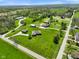 Scenic aerial view showcasing the residence, outbuildings, and sprawling green lawn with mature trees on a lovely property at 8890 N Pennington Rd, Mooresville, IN 46158