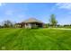 A stunning backyard featuring a large lawn and a covered patio, perfect for relaxing at 8890 N Pennington Rd, Mooresville, IN 46158