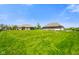 Spacious backyard featuring an expansive lush green lawn, and a view of the beautiful brick home and outbuilding at 8890 N Pennington Rd, Mooresville, IN 46158