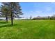 A lush green lawn leads up to the house, complemented by a clear blue sky at 8890 N Pennington Rd, Mooresville, IN 46158