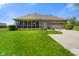 The backyard features well-manicured green grass and an attached garage on a sunny day at 8890 N Pennington Rd, Mooresville, IN 46158