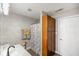 A neutral bathroom features gray walls, a tall wooden linen cabinet, and a shower with a patterned curtain at 8890 N Pennington Rd, Mooresville, IN 46158