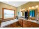 Bathroom featuring double sinks, granite countertops, and soaking tub at 8890 N Pennington Rd, Mooresville, IN 46158