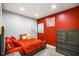 This bedroom features a striking red accent wall with neutral-colored walls and carpet at 8890 N Pennington Rd, Mooresville, IN 46158