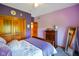 Comfortable bedroom with stylish decor, a bed with soft bedding, and purple accent walls at 8890 N Pennington Rd, Mooresville, IN 46158