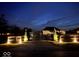 Night view of an attractive illuminated entry gate with gravel drive leading into the property at 8890 N Pennington Rd, Mooresville, IN 46158