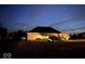 Cozy single-story home featuring a two-car garage and well-manicured landscaping at dusk at 8890 N Pennington Rd, Mooresville, IN 46158