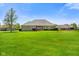 Charming home featuring a lush green lawn and manicured landscaping with a view of the rear facade of the home at 8890 N Pennington Rd, Mooresville, IN 46158