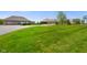 Manicured lawn leads to a charming home with an attached garage, and a matching outbuilding with garage bays at 8890 N Pennington Rd, Mooresville, IN 46158