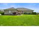 Charming single story home featuring a well-manicured lawn, lush landscaping, and a brick facade at 8890 N Pennington Rd, Mooresville, IN 46158