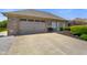 View of the front exterior with a two-car garage and landscaping along the side of the home at 8890 N Pennington Rd, Mooresville, IN 46158