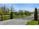 Ornate wrought iron estate gate provides an elegant entrance, flanked by manicured greenery and sturdy fencing at 8890 N Pennington Rd, Mooresville, IN 46158