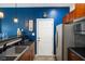 Stylish kitchen features a modern sink, sleek countertop, and stainless steel refrigerator with a blue accent wall at 8890 N Pennington Rd, Mooresville, IN 46158