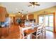 Open-concept kitchen and dining area features wood cabinetry, stainless appliances, and hardwood floors at 8890 N Pennington Rd, Mooresville, IN 46158