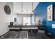 Modern kitchen with stainless steel sink, stylish pendant lights, and bold blue accent wall at 8890 N Pennington Rd, Mooresville, IN 46158