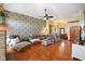 Spacious living room featuring a decorative accent wall, hardwood floors, and comfortable seating at 8890 N Pennington Rd, Mooresville, IN 46158