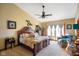 Spacious main bedroom features a cozy seating area, a ceiling fan, and lots of natural light at 8890 N Pennington Rd, Mooresville, IN 46158