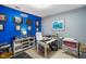 Home office with a blue accent wall, built-in shelving, and a sleek white desk setup at 8890 N Pennington Rd, Mooresville, IN 46158