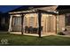 Relaxing backyard patio with a wooden pergola, an outdoor dining set, and curtains for privacy at 8890 N Pennington Rd, Mooresville, IN 46158