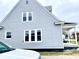 Side view of a gray house featuring updated siding and white-trimmed windows at 902 E 31St St, Anderson, IN 46016