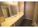 Bathroom featuring a large mirror, and a long vanity, with linoleum floors at 928 Hoover Village Dr # 928D, Indianapolis, IN 46260
