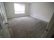 A cozy bedroom with neutral carpet, window with blinds, and freshly painted walls at 928 Hoover Village Dr # 928D, Indianapolis, IN 46260