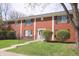 Charming brick townhouse featuring a well-manicured lawn and welcoming blue front door at 928 Hoover Village Dr # 928D, Indianapolis, IN 46260