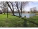 Scenic pond view surrounded by green grass and community buildings at 928 Hoover Village Dr # 928D, Indianapolis, IN 46260