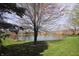 Exterior shot of a pond surrounded by community buildings and lawn at 928 Hoover Village Dr # 928D, Indianapolis, IN 46260