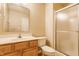 Bathroom with wood vanity, large mirror, toilet, and glass enclosed shower at 9763 Rolling Plain Dr, Noblesville, IN 46060