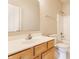 Well-lit bathroom with wood vanity, large mirror, and shower-tub combination at 9763 Rolling Plain Dr, Noblesville, IN 46060
