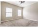 Spacious bedroom featuring neutral carpet, ceiling fan, and natural light from the two windows at 9763 Rolling Plain Dr, Noblesville, IN 46060