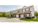 A row of beautiful townhouses with brick and vinyl siding, attached garages, and well-manicured lawns at 9763 Rolling Plain Dr, Noblesville, IN 46060