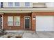 The front of a beautiful townhouse with red brick, a front door, and an attached garage at 9763 Rolling Plain Dr, Noblesville, IN 46060