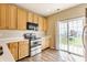 Well-lit kitchen with wood laminate floors, stainless steel appliances, and plenty of natural light at 9763 Rolling Plain Dr, Noblesville, IN 46060